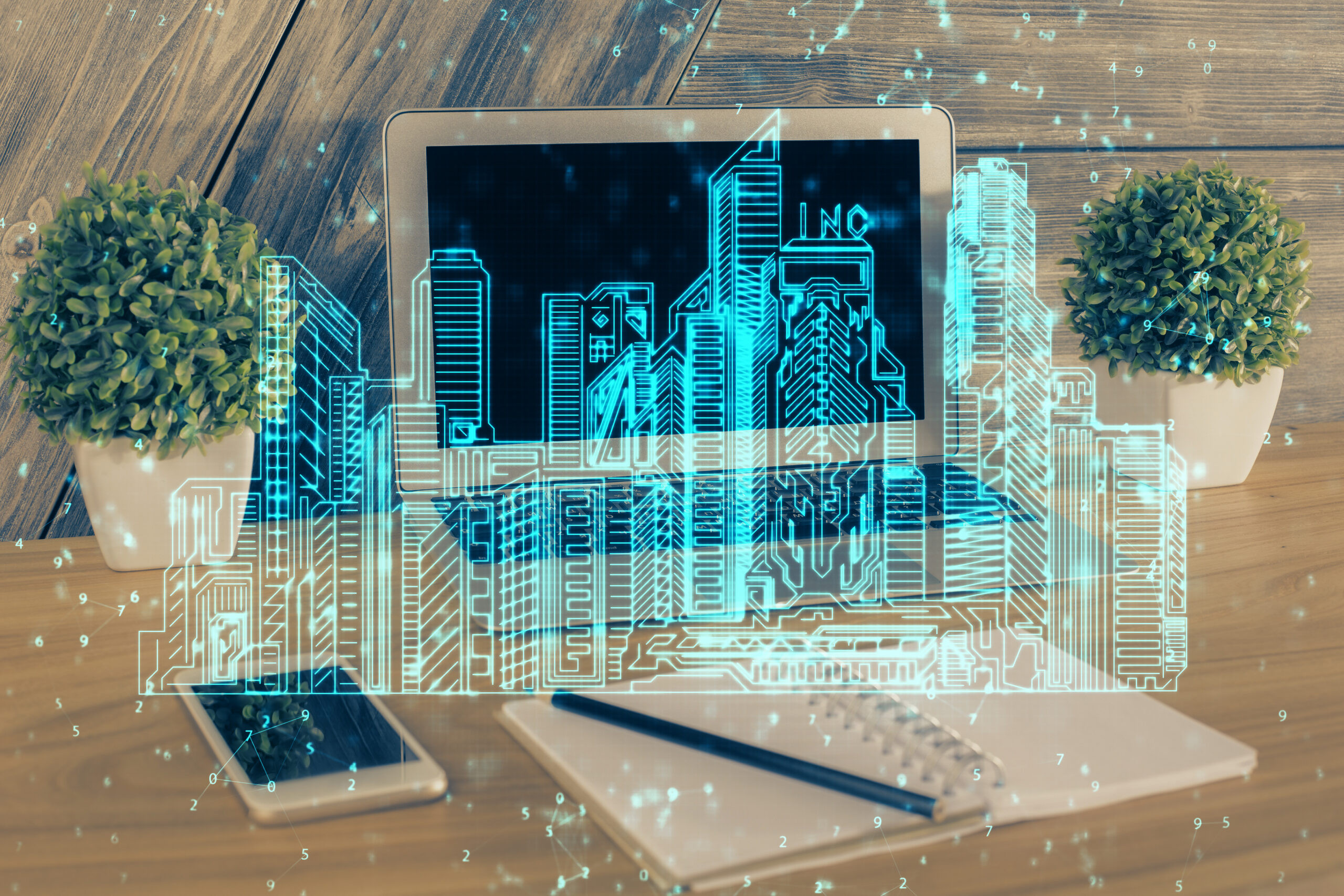 Desktop computer background in office and big town buildings hologram drawing. Double exposure. Smart city concept.